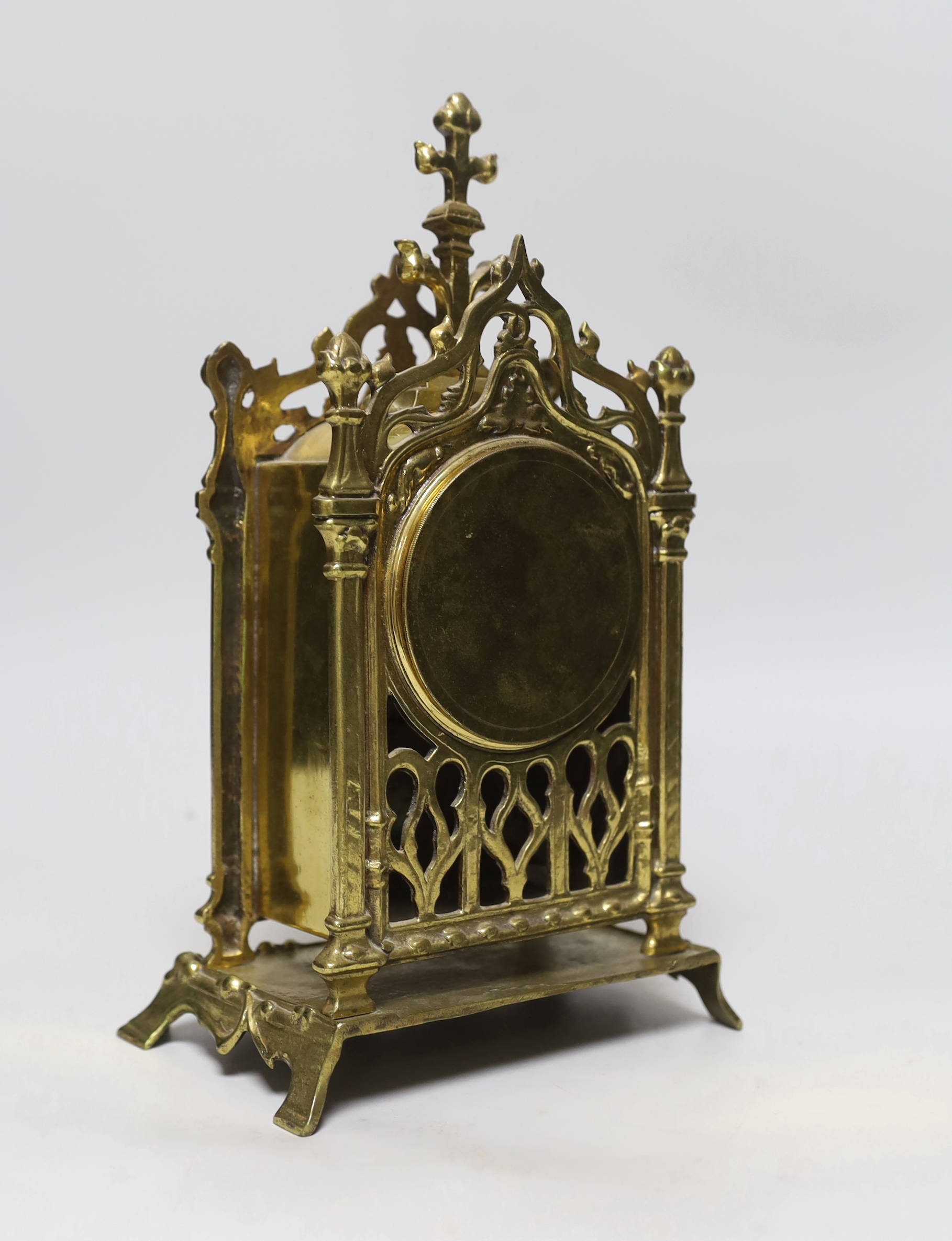 A Gothic style brass timepiece, 28cm tall, with key